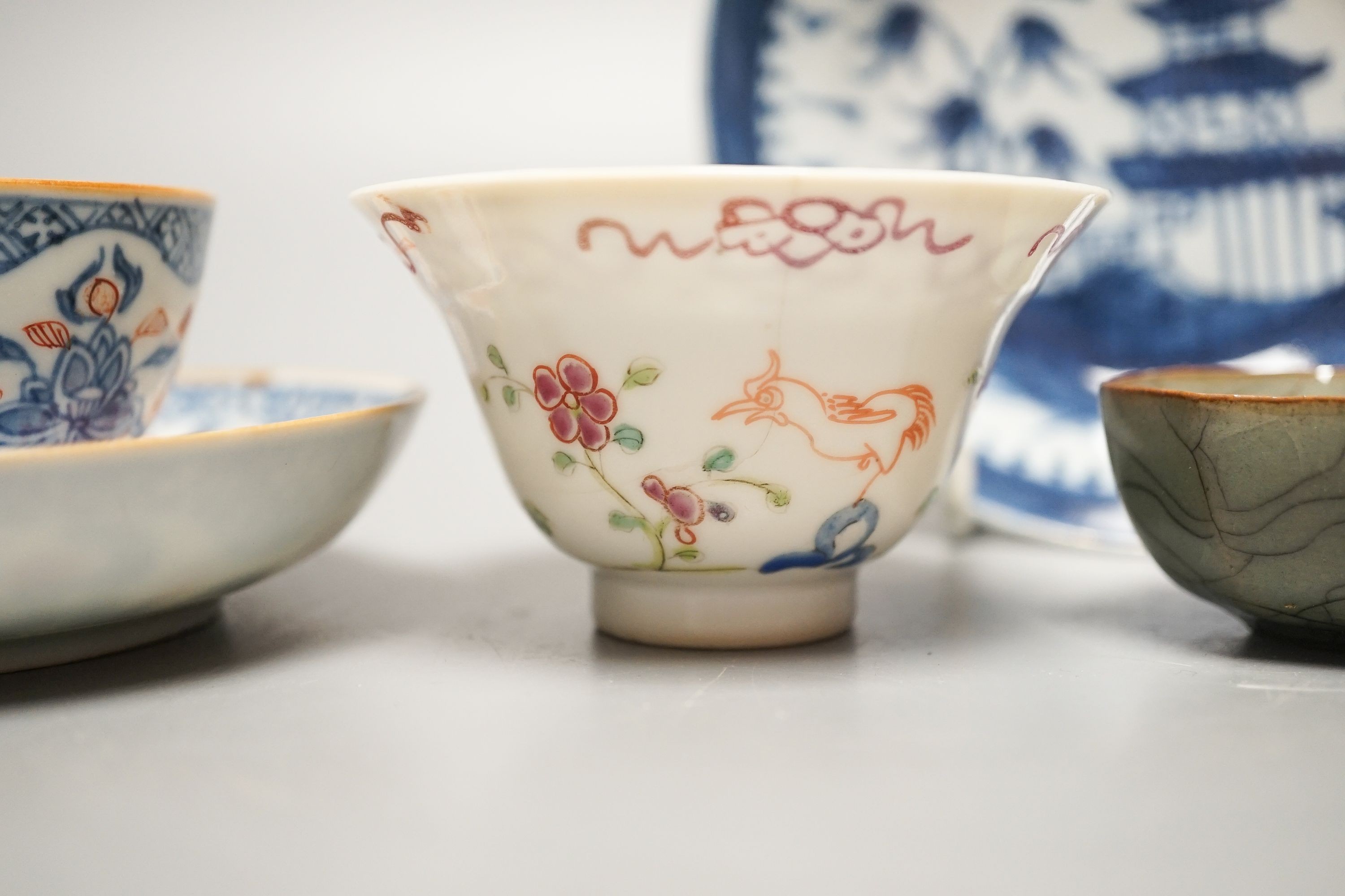 A Chinese Imari tea bowl and saucer, a famille rose tea bowl, a saucer and a celadon glazed cup